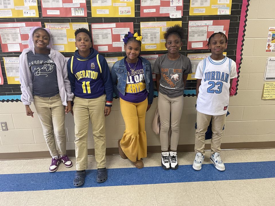A group of children standing in a classroomAI-generated content may be incorrect.